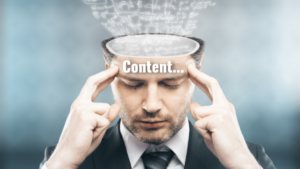 Man in a suit holds his temples with eyes closed, a glowing brain outline above, and the word 'Content...'—illustrating thinking about content strategy conceptually.