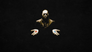 Man in sunglasses extends his hands, offering a red pill in one palm and a blue pill in the other against a black background.