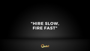 Dark gradient poster with the quote 'HIRE SLOW, FIRE FAST' centered, and a small gold key icon at the bottom.