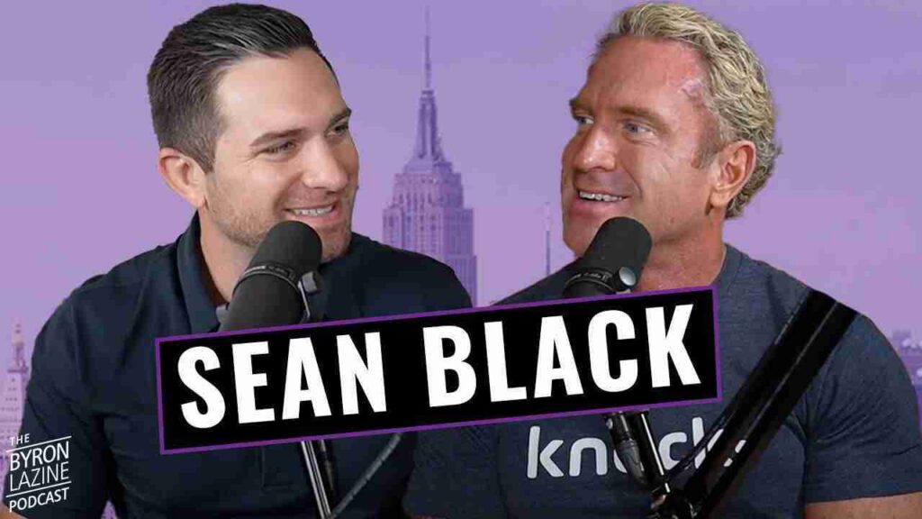Two men sit at microphones in a podcast studio, with a bold SEAN BLACK banner across and a purple city skyline background. The Byron Lazine Podcast logo appears bottom left.