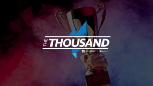 Award trophy raised by a hand against a purple-blue smoky background, with 'THE THOUSAND 2022' and geometric blue shapes overlaying the image.