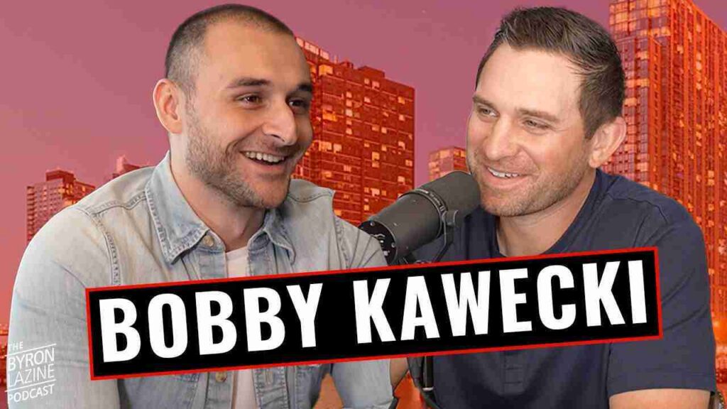 Two men sit close together, smiling and talking into a microphone for a podcast with a bold name banner across the front.