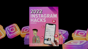 Book cover '2022 Instagram Hacks' with a cartoon man and a hand holding a phone showing an Instagram feed on a pink background with hearts and floating icons
