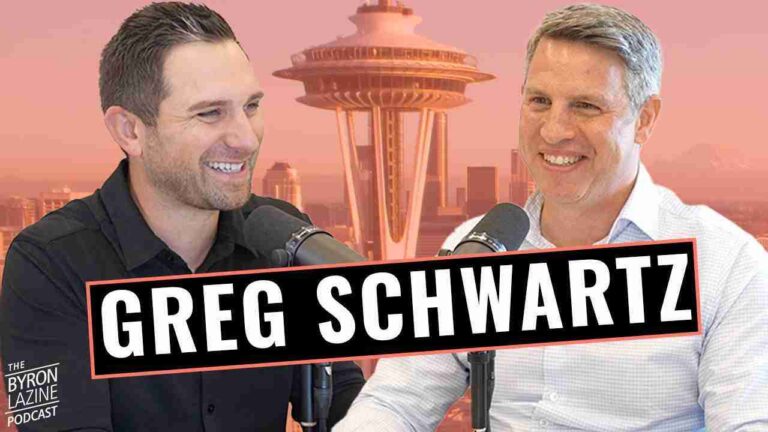 Two men smile into microphones during a podcast interview, with a bold 'GREG SCHWARTZ' banner and a pink skyline backdrop including the Space Needle.