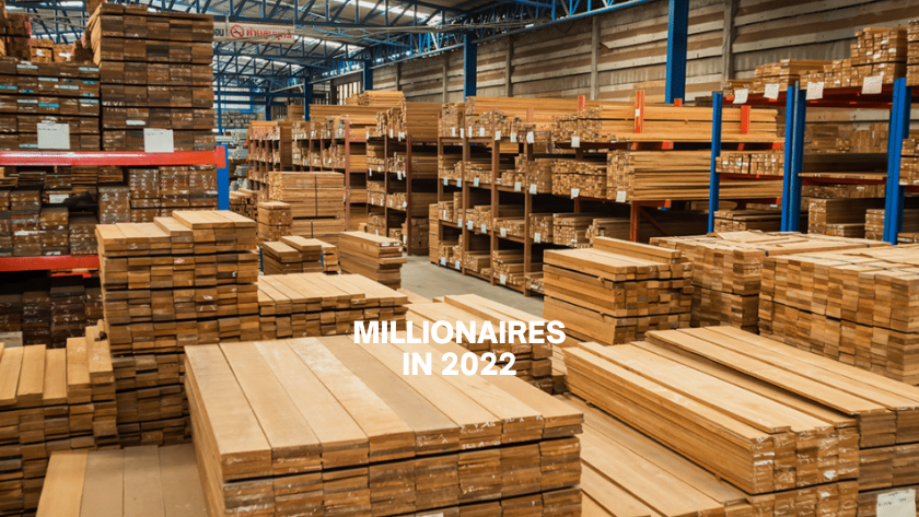 Interior lumber warehouse with stacked boards and shelves; overlay text reads 'MILLIONAIRES IN 2022'