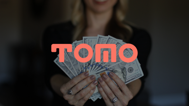 Woman holding a fan of US dollar bills with a pink TOPQ logo overlaid