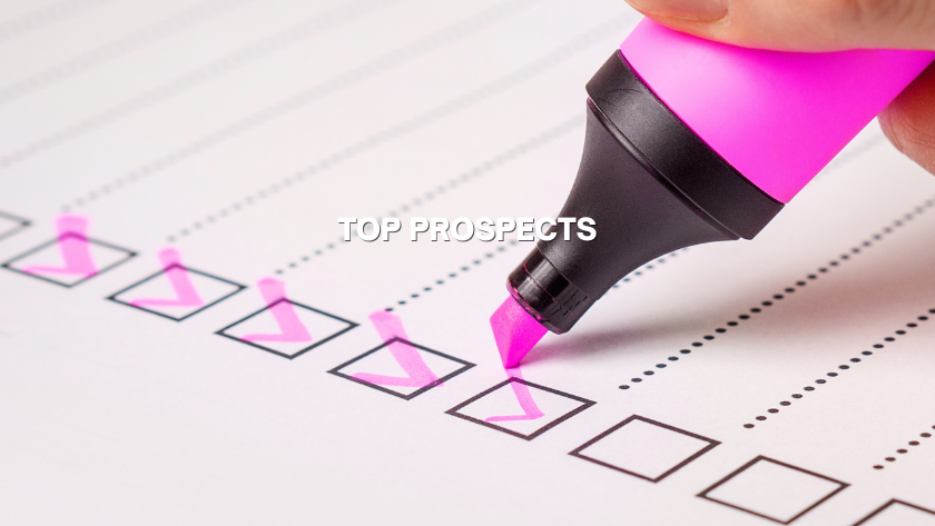 Close-up of a pink highlighter marking checkboxes on a checklist labeled Top Prospects.