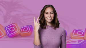 Smiling woman in a purple sweater making a peace sign with Instagram logo blocks in a pink background behind her.
