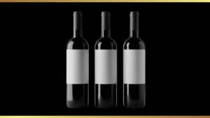 Three dark wine bottles with blank white labels lined up on a black background inside a gold-bordered frame