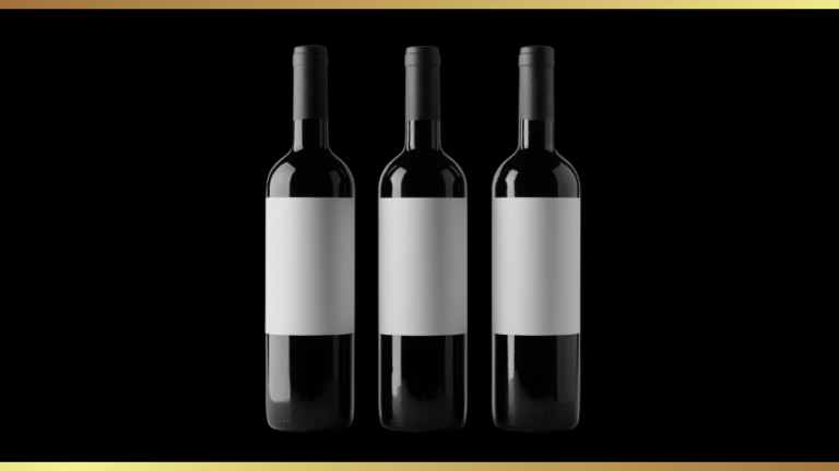 Three dark wine bottles with blank white labels lined up on a black background inside a gold-bordered frame