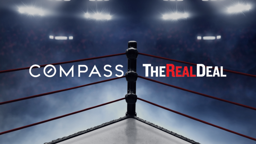 Wrestling ring ropes and corner post under bright arena lights with the text 'COMPASS THE REAL DEAL' across the ropes.