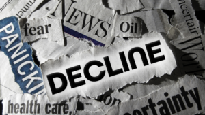 Collage of torn newspaper clippings with the bold word DECLINE across the center, suggesting economic or market downturn.