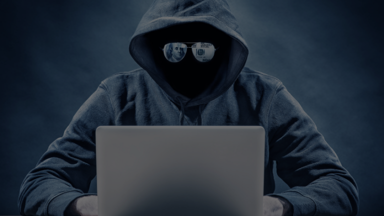 Hooded figure typing on a laptop, face obscured, sunglasses reflecting money in a dark blue scene.