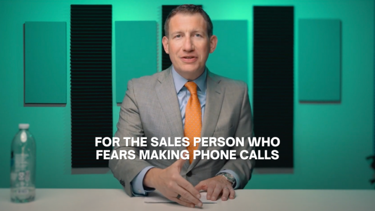 Video thumbnail: a man in a gray suit with an orange tie at a desk, with the caption 'For the sales person who fears making phone calls'