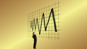 Businesswoman studying a large jagged line chart on a grid wall, symbolizing market volatility.