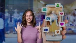 Smiling woman in a purple sweater beside a smartphone showing floating social media icons. (connectivity)