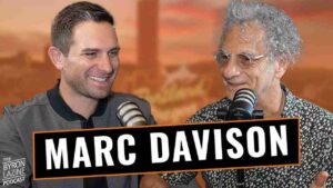 Two podcast hosts with microphones; a bold 'MARC DAVISON' banner runs across the foreground as they smile and chat.