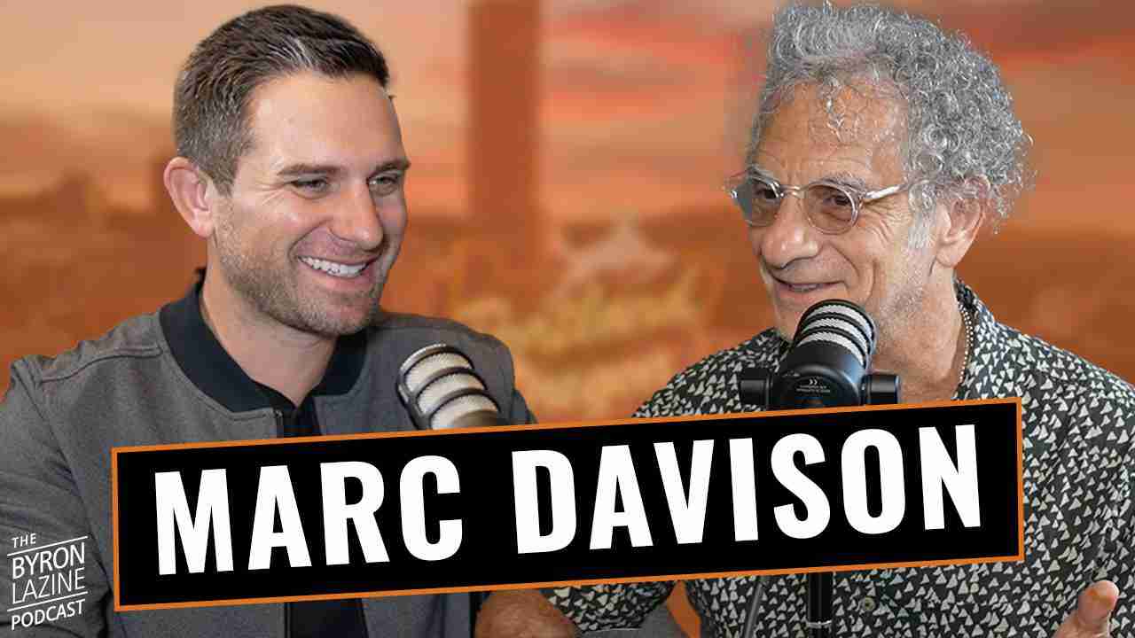 Two podcast hosts with microphones; a bold 'MARC DAVISON' banner runs across the foreground as they smile and chat.