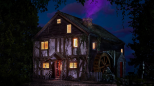 Old timber mill house at night with warm glowing windows, ivy along the walls and a large wooden water wheel nearby.