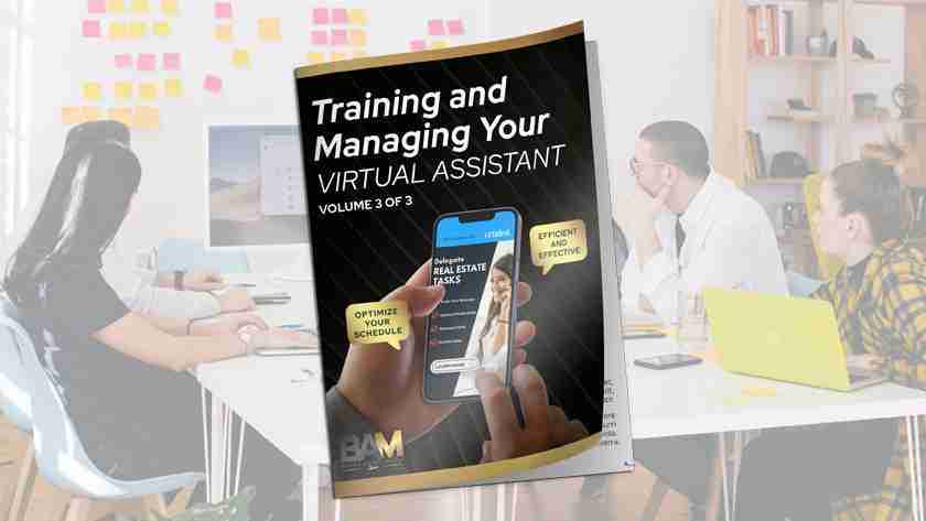 Magazine cover titled 'Training and Managing Your Virtual Assistant' held up in a bright office, showing a hand using a smartphone and stylus in the foreground.