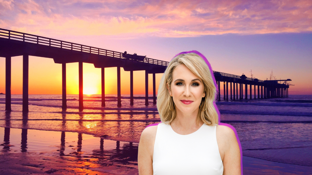 Sunset over a long pier extending into the ocean, with a smiling woman in a white sleeveless top in the foreground.