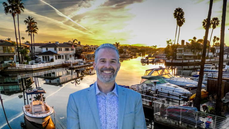 Smiling man in a blue blazer over a marina at sunset, with boats and palm trees in the background, as a cutout image.