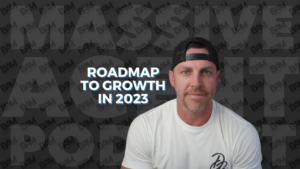 Portrait of a man in a white shirt and backward cap, overlaid with bold 'Roadmap to Growth in 2023' copy for a growth-focused feature. Background features a dark BAM watermark pattern.