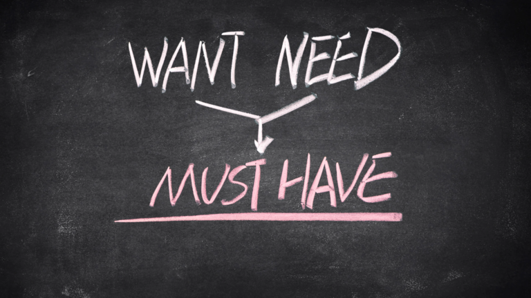 Chalkboard showing 'WANT' and 'NEED' connected by a branch, pointing to pink 'MUST HAVE' text below underlined.