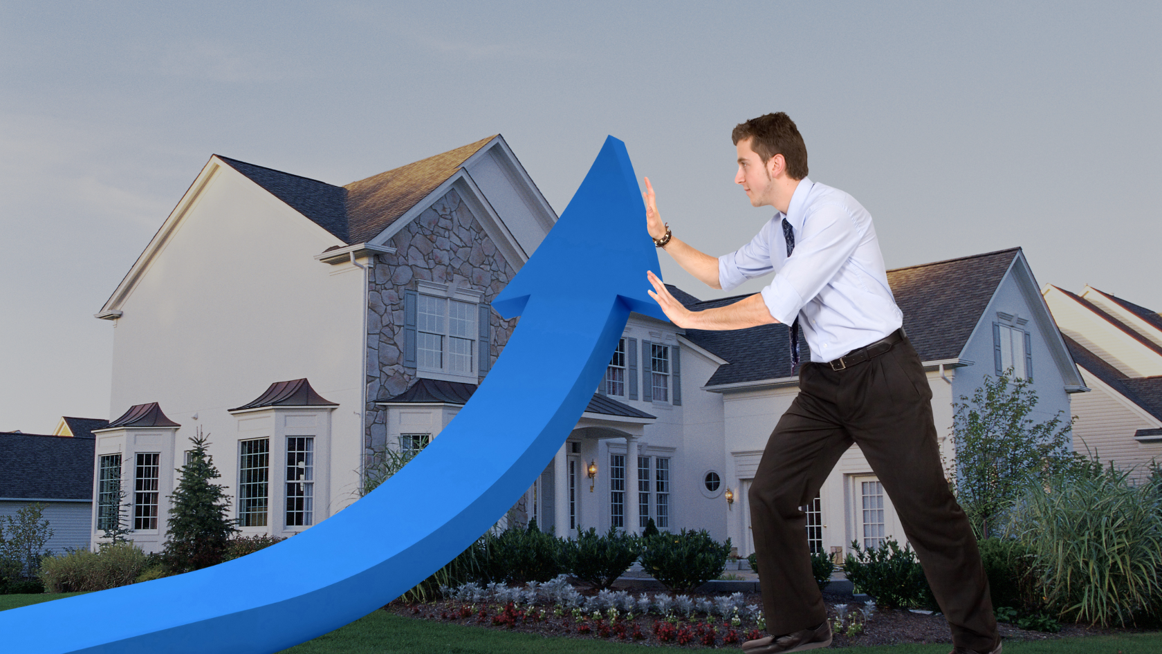 Man in a dress shirt and tie pushes a giant blue arrow upward in front of a suburban house, symbolizing rising real estate growth.