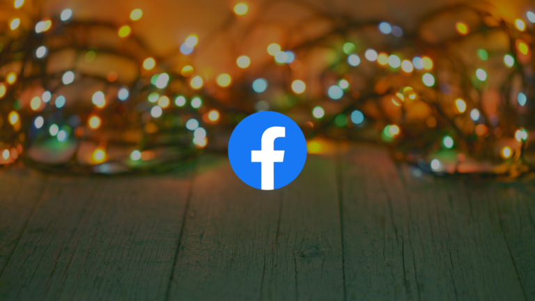 Facebook logo centered on colorful bokeh lights with a wooden surface background in warm tones.