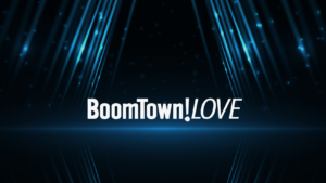 Logo with the text 'BoomTown!LOVE' in bold white font on a dark blue neon background with surrounding light beams.