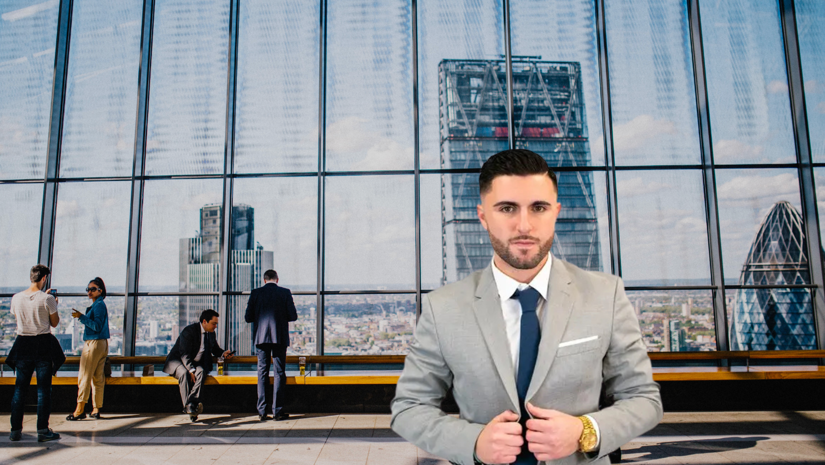 Man in a gray suit and navy tie stands in the foreground of a glass-walled office lobby with the city skyline behind him.