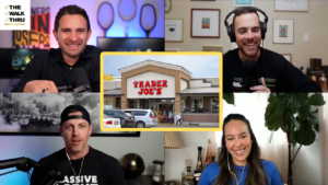 Six-person video call grid: a central framed photo of Trader Joe's storefront in a yellow border, surrounded by four hosts with microphones/headphones and a logo banner reading 'THE WALK THRU' in the top-left corner.