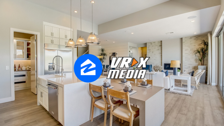 Open-concept kitchen and living room with white cabinets, island, and gray decor; VRX MEDIA logo centered over the scene.