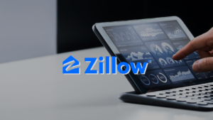 Tablet displaying data dashboards with graphs and charts, overlaid by the blue Zillow logo and a fingertip touching the screen.