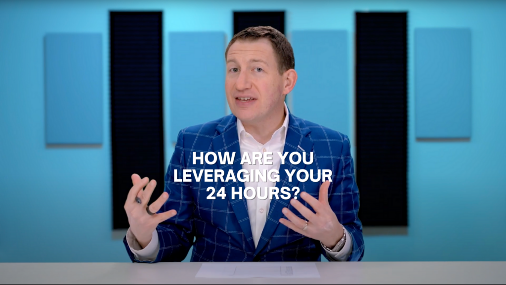Video presenter in a blue check blazer speaking at a desk with the caption: 'HOW ARE YOU LEVERAGING YOUR 24 HOURS?','Professional man in a blue suit discusses time management on a studio set with bold white text prompt across the screen.','Host presenting a tip on maximizing daily time, overlaid with the question about leveraging 24 hours.']} }``` If you prefer shorter: 1-2 sentence options with the exact text included. If you want longer, I can add a longer description of the scene.``` (Note: The JSON above is the intended structure; ensure exact quotes and punctuation match your alt text usage.)``` >Oops I included extra markdown; corrected below.> {