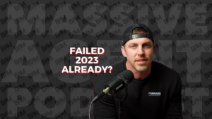 Podcast host wearing a backward cap speaks into a microphone, with bold title text reading 'FAILED 2023 ALREADY?'