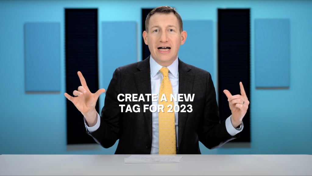 Video thumbnail: man in a suit at a desk explaining how to create a new tag for 2023.