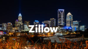 Night city skyline with illuminated skyscrapers and flames in the foreground, overlaid by a large Zillow watermark.