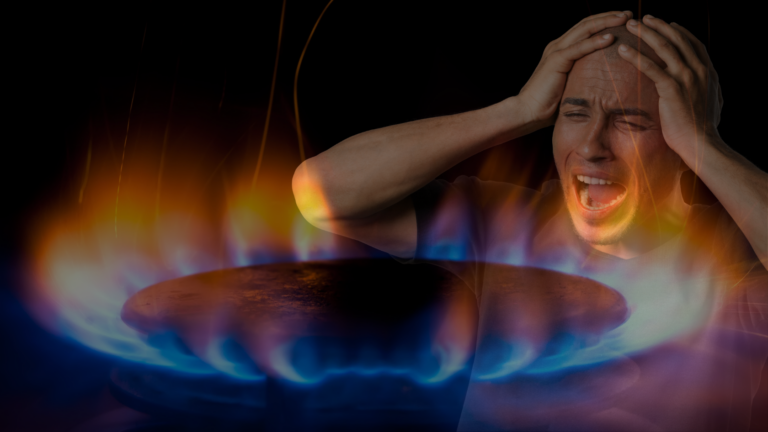 A man screams in front of a gas stove with blue and orange flames, hands on his head in distress.