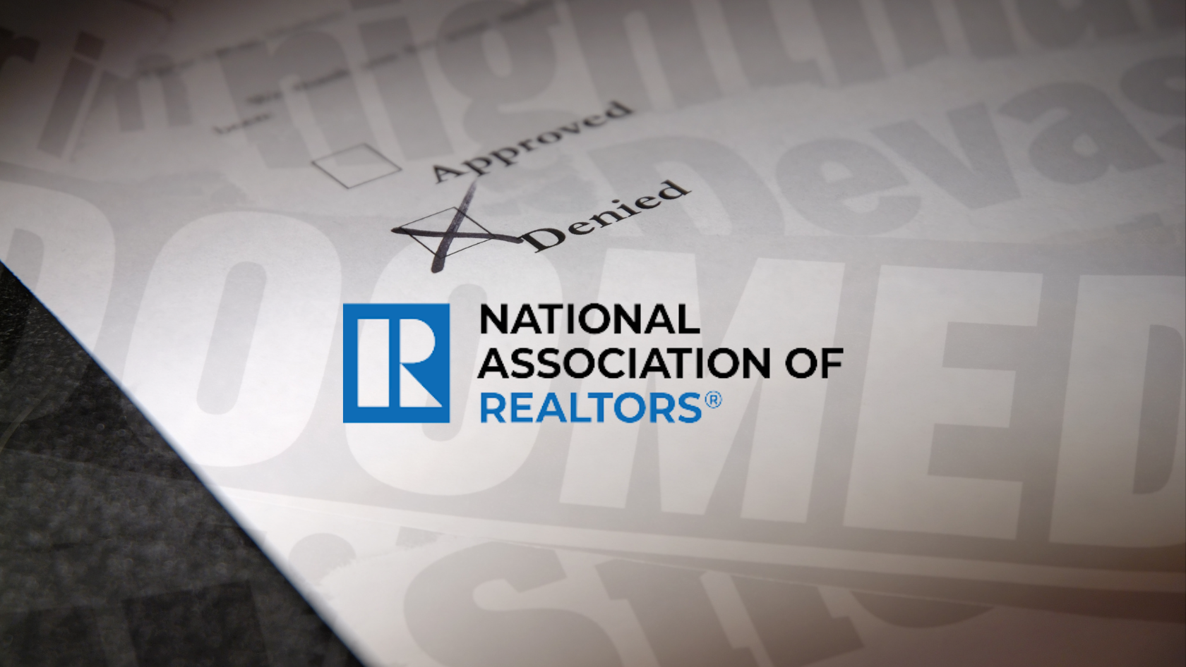Close-up of a document with a large 'Denied' stamp and the National Association of Realtors logo in view.