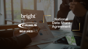 Hero banner showing real estate data collaboration logos (Bright MLS, CRMLS, BEACH MLS) with 'National Data Share Agreement' text on the right side of a business meeting scene.