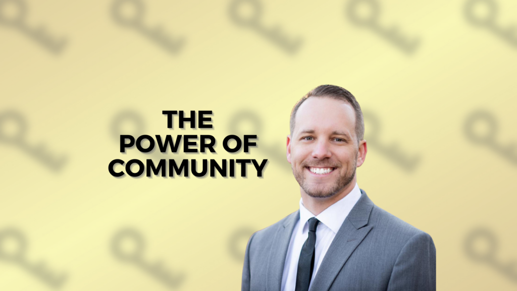 Smiling man in a gray suit stands to the right of bold text that reads 'The Power of Community' on a pale yellow background with a soft pattern.
