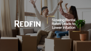 Couple celebrating on a sofa amid moving boxes, illustrating slower rental rates reducing inflation impact.
