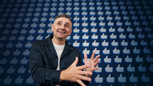 Man smiling and gesturing enthusiastically in front of a wall of blue thumbs-up icons.