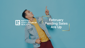 Man in a denim jacket points upward beside a teal backdrop, with the National Association of Realtors logo and the headline 'February Pending Sales Are Up'.