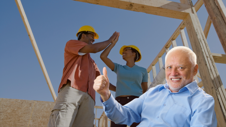 Two construction workers high-five on a wooden frame; a smiling older man in the foreground gives a thumbs-up.