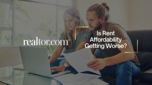 Couple reviewing papers on a couch with a laptop, overlaid by realtor.com’s banner text about rent affordability getting worse.