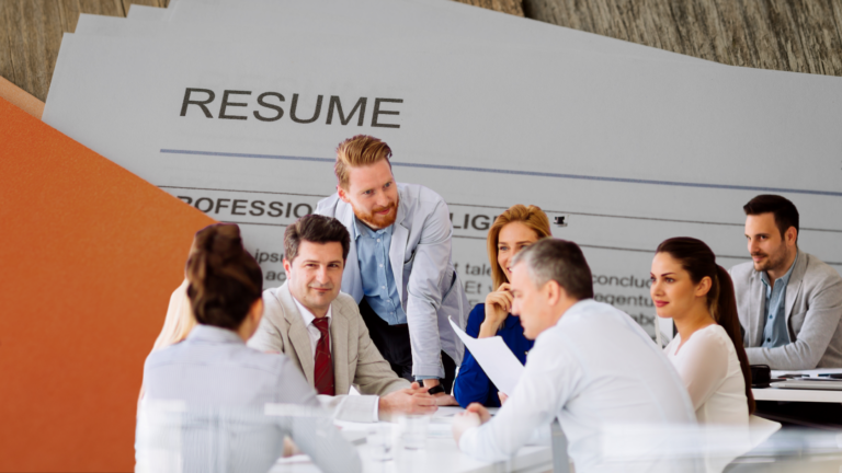 Team of professionals in a meeting around a table, with a large resume document as a backdrop behind them.