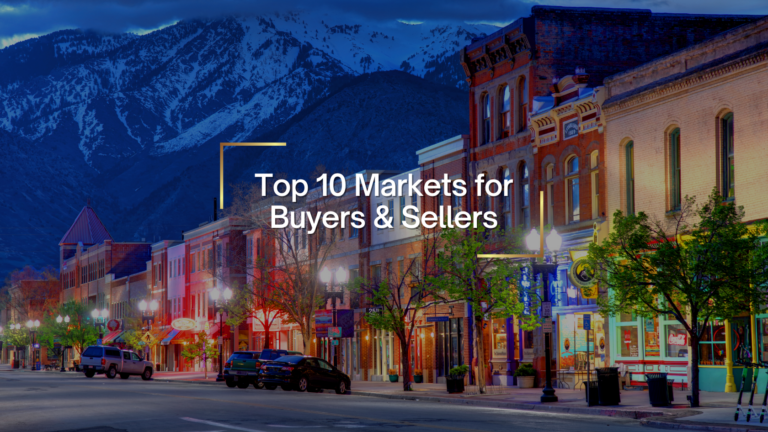 Mountain town street at dusk with colorful storefronts and the overlay text 'Top 10 Markets for Buyers & Sellers'